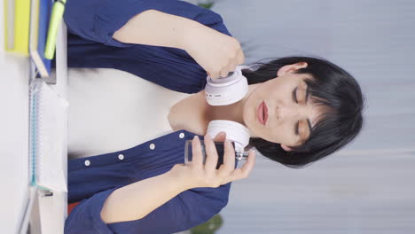 Vertical-video-of-A-Female-student-spraying-perfume.